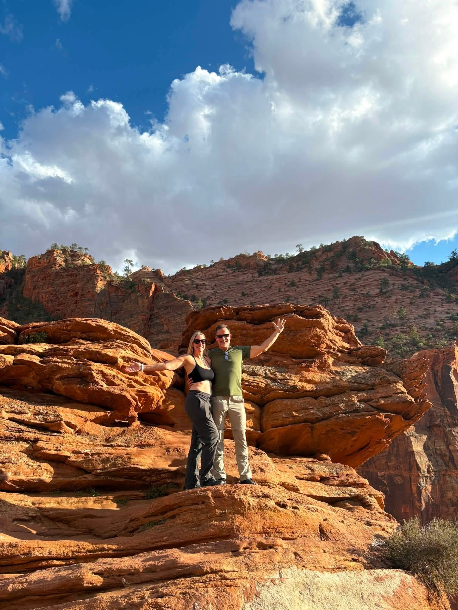 Stephanie hiking through red rock canyon — arms wide open, full of joy